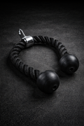 Black tricep rope cable attachment with rubber end grips on dark textured background for home gym strength training